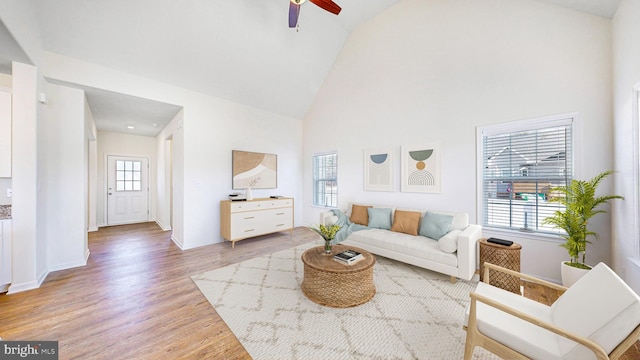 living room with hardwood / wood-style floors, high vaulted ceiling, a wealth of natural light, and ceiling fan