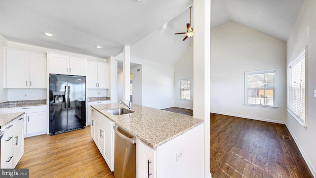 kitchen with black refrigerator with ice dispenser, sink, dishwasher, and light hardwood / wood-style flooring