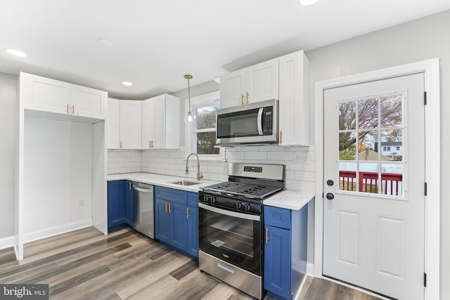 kitchen featuring sink, white cabinets, stainless steel appliances, and blue cabinets