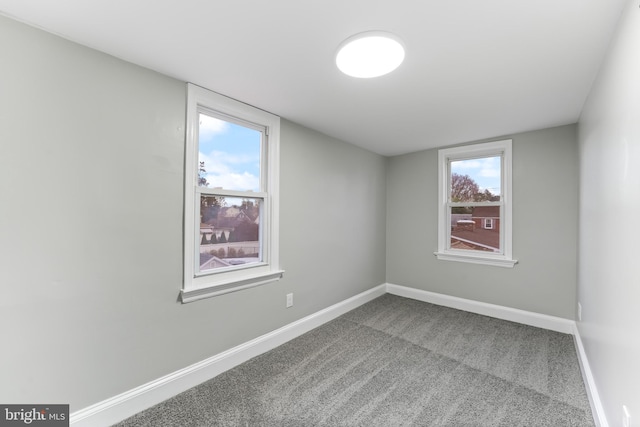 carpeted empty room with plenty of natural light