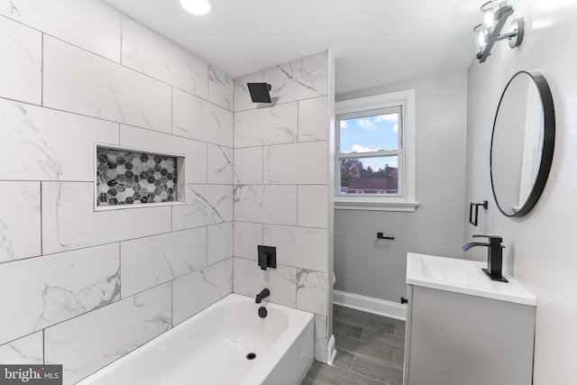 full bathroom with vanity, tiled shower / bath combo, and toilet