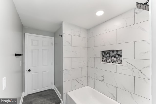 bathroom featuring hardwood / wood-style flooring and tiled shower / bath