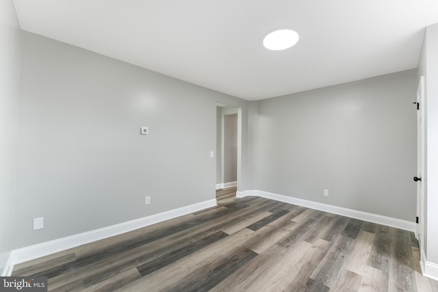 unfurnished room featuring dark hardwood / wood-style floors