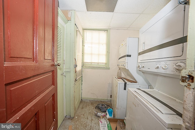 laundry area featuring cabinets and stacked washer and dryer