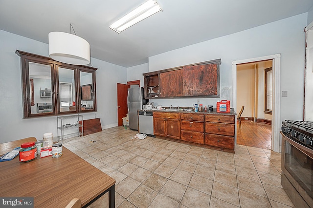 kitchen featuring appliances with stainless steel finishes, light hardwood / wood-style flooring, and sink