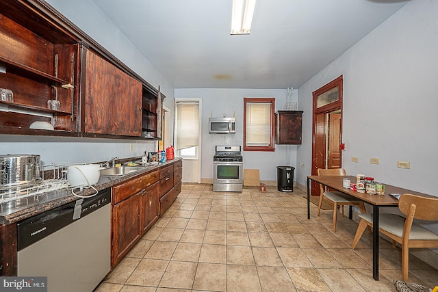 kitchen featuring appliances with stainless steel finishes, light tile patterned floors, and sink