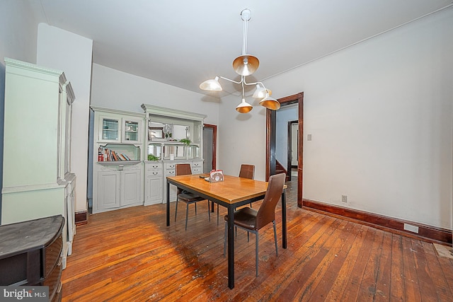 dining area with an inviting chandelier and hardwood / wood-style flooring