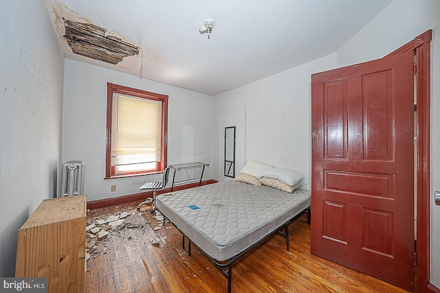 bedroom featuring light hardwood / wood-style floors and lofted ceiling