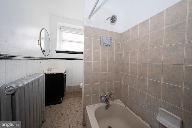 bathroom with vanity, toilet, and radiator