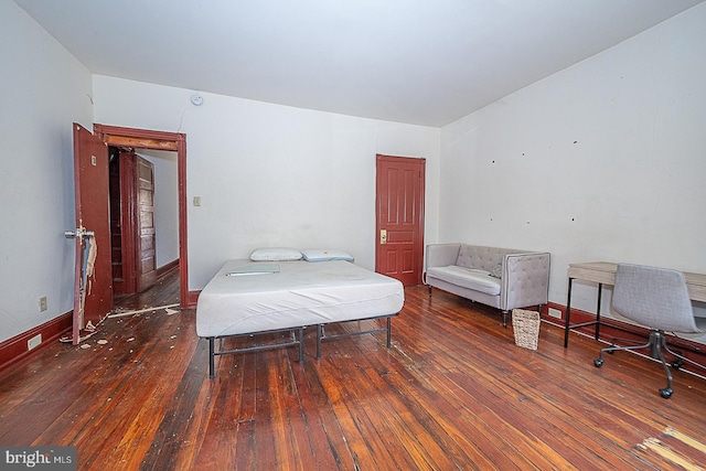 bedroom with dark wood-type flooring