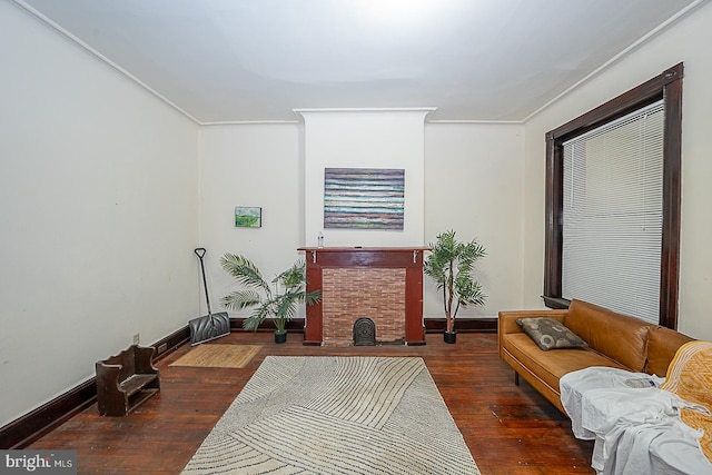 living room with dark hardwood / wood-style flooring and ornamental molding