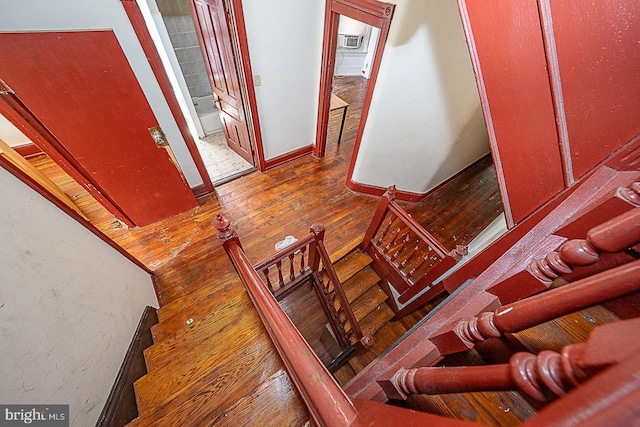 stairs with hardwood / wood-style flooring