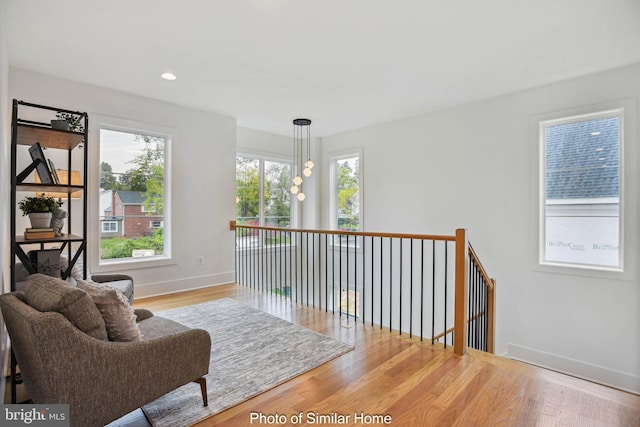 8202 Mockingbird Dr, Annandale, VA 22003 - living area featuring baseboards, recessed lighting, wood finished floors, and an upstairs landing