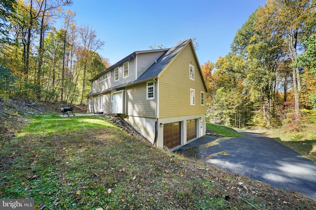 view of side of home featuring a garage