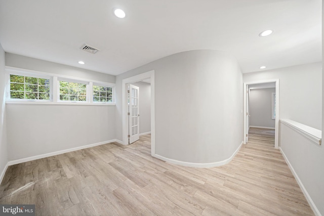 spare room with light wood-type flooring