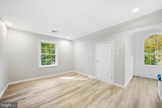 unfurnished room featuring plenty of natural light and light hardwood / wood-style flooring