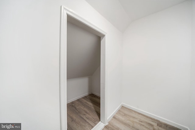 interior space with light hardwood / wood-style floors and lofted ceiling