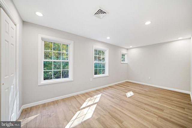 spare room with light hardwood / wood-style flooring