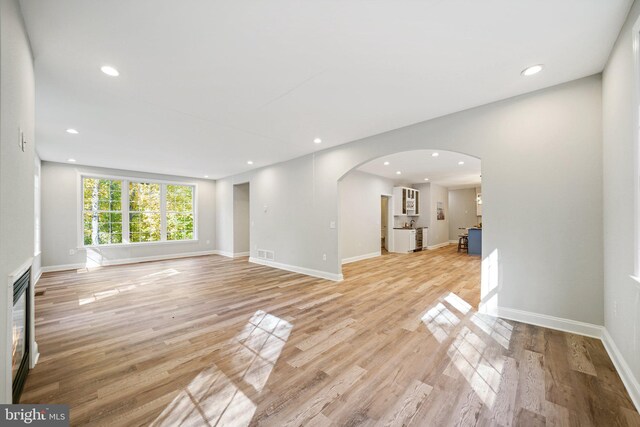 unfurnished living room featuring light wood-type flooring