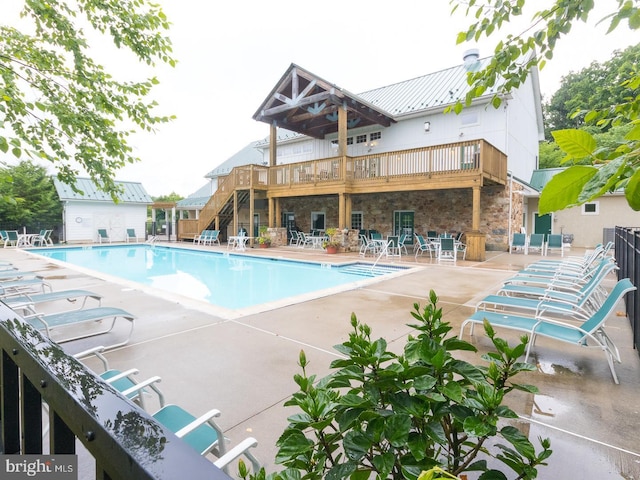 view of swimming pool with a patio