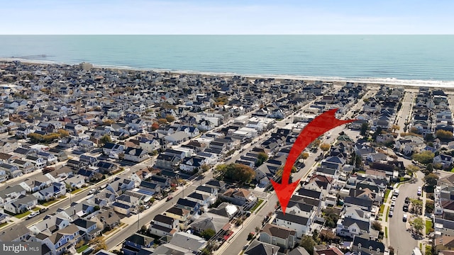 birds eye view of property with a beach view and a water view