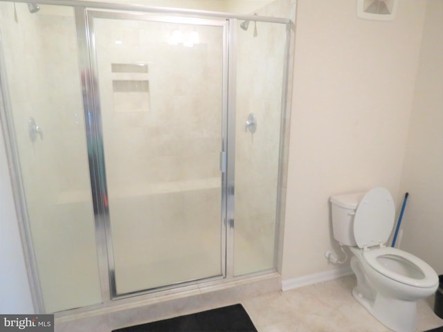 bathroom with an enclosed shower and toilet