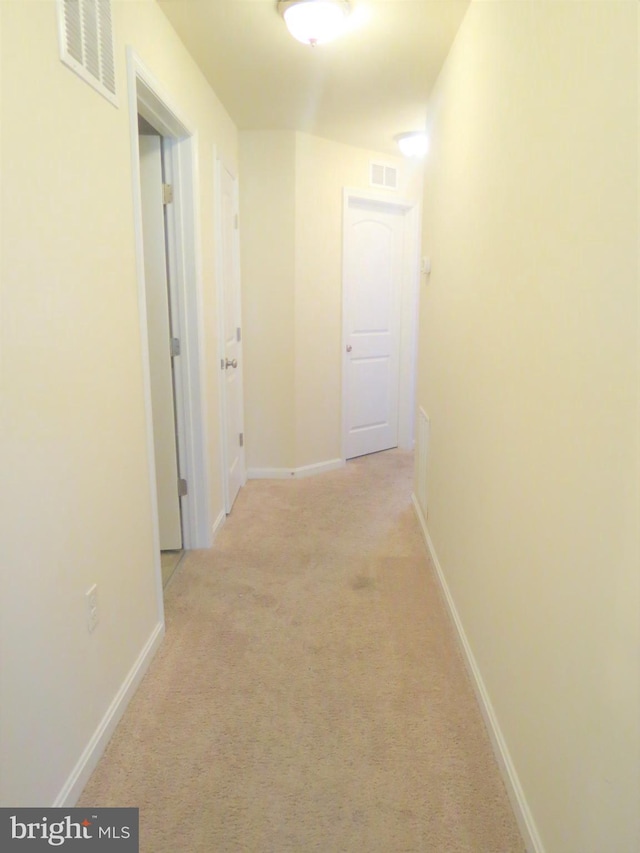 hallway featuring light carpet