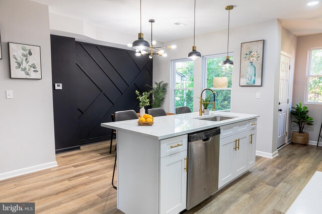 kitchen featuring white cabinetry, dishwasher, sink, a center island with sink, and light wood-type flooring