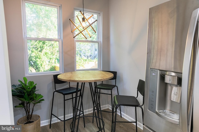 dining room with plenty of natural light and wood-type flooring