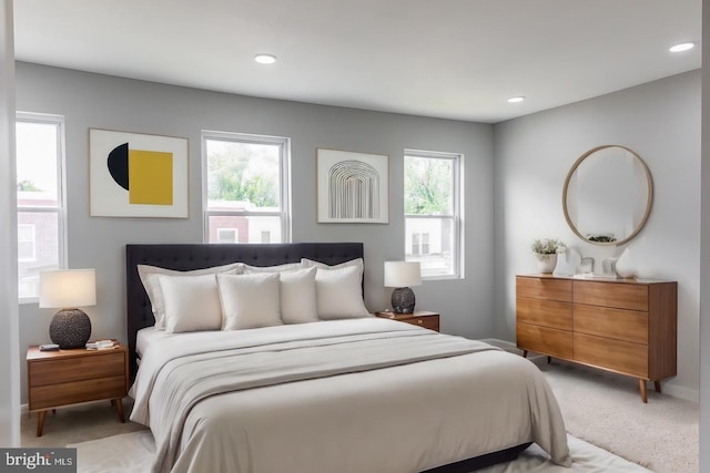 carpeted bedroom featuring multiple windows