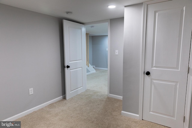 hallway with light colored carpet