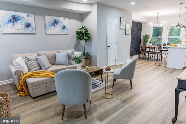 living room with hardwood / wood-style floors and a chandelier