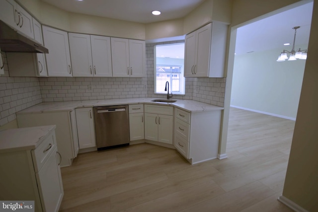 kitchen featuring white cabinets, dishwasher, light wood-type flooring, and sink