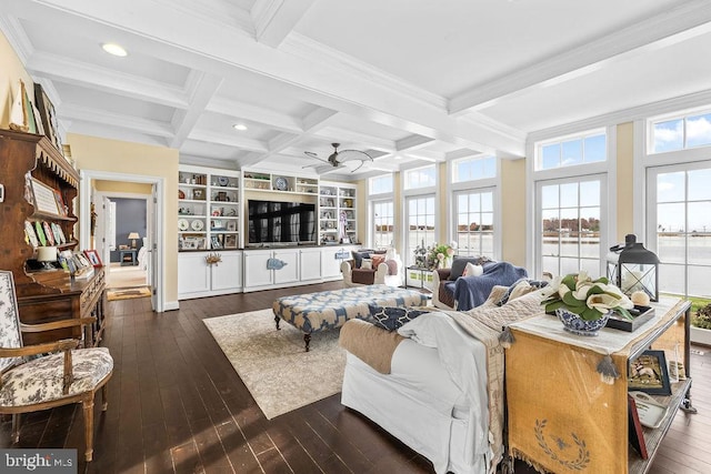 living room with beam ceiling, ceiling fan, a wealth of natural light, and coffered ceiling