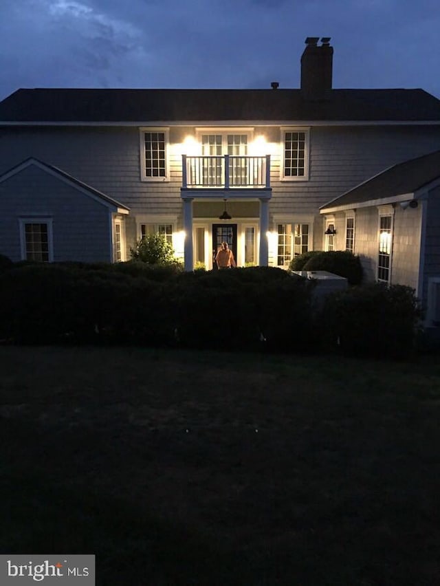 back of property with a balcony