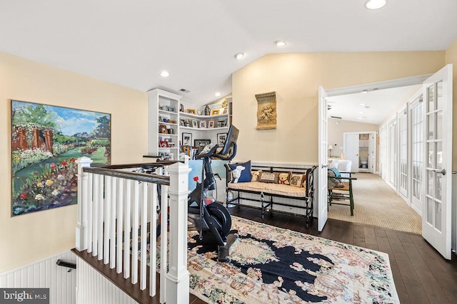 exercise area featuring vaulted ceiling and dark hardwood / wood-style flooring