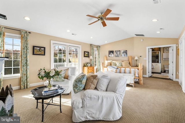 carpeted bedroom featuring ceiling fan, multiple windows, and vaulted ceiling