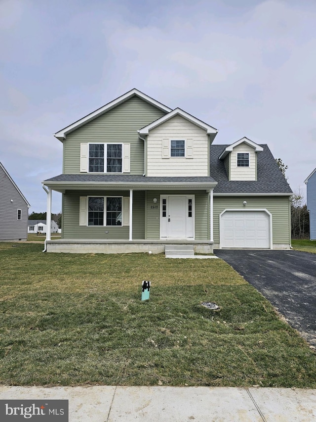 view of front of house featuring covered porch, a front yard, and a garage