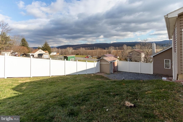 view of yard with a mountain view and a storage shed