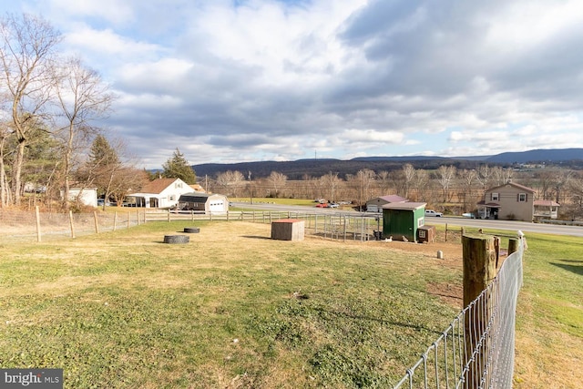 view of yard with a mountain view and a rural view