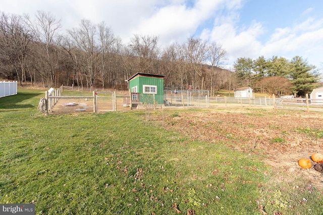 view of yard with an outbuilding and a rural view