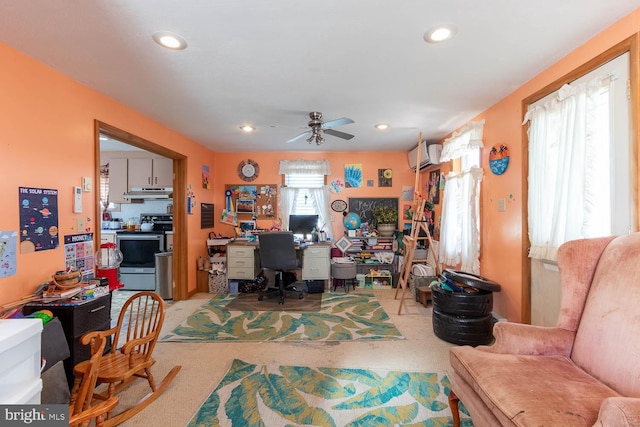 office space with a wall mounted AC and ceiling fan