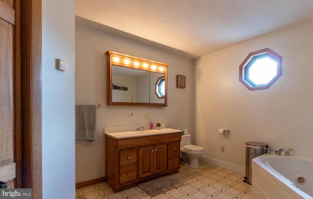 bathroom featuring a tub to relax in, vanity, and toilet