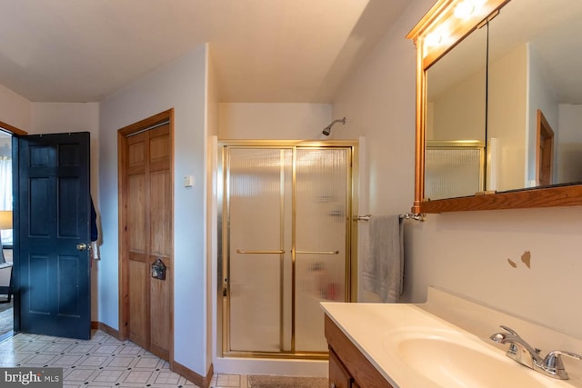 bathroom with a shower with door and vanity