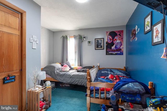 bedroom featuring carpet flooring and a textured ceiling