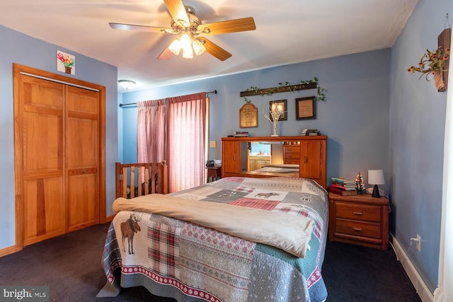 carpeted bedroom featuring a closet and ceiling fan