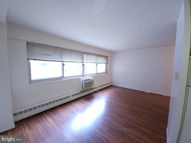 unfurnished room featuring baseboard heating and hardwood / wood-style flooring