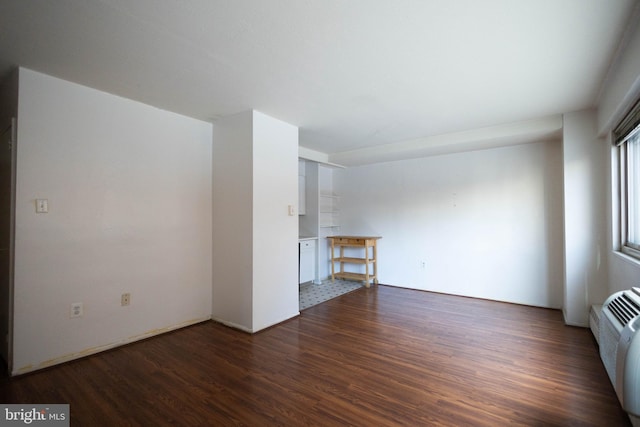 2101 Chestnut St Unit 401, Philadelphia, PA 19103 - unfurnished living room featuring dark wood-type flooring and a wall mounted air conditioner