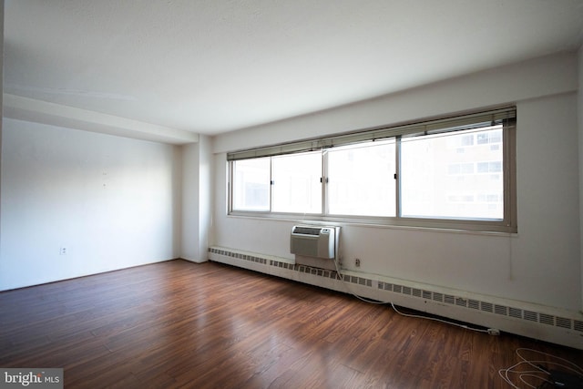 2101 Chestnut St Unit 401, Philadelphia, PA 19103 - spare room featuring a baseboard heating unit, wood finished floors, and a wall mounted AC