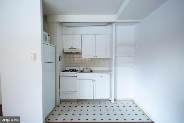 2101 Chestnut St Unit 401, Philadelphia, PA 19103 - kitchen with white appliances, light floors, a sink, under cabinet range hood, and white cabinets